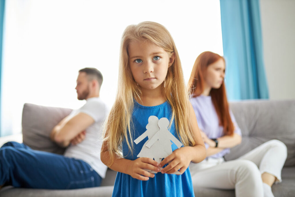 Young girl between parent in conflict